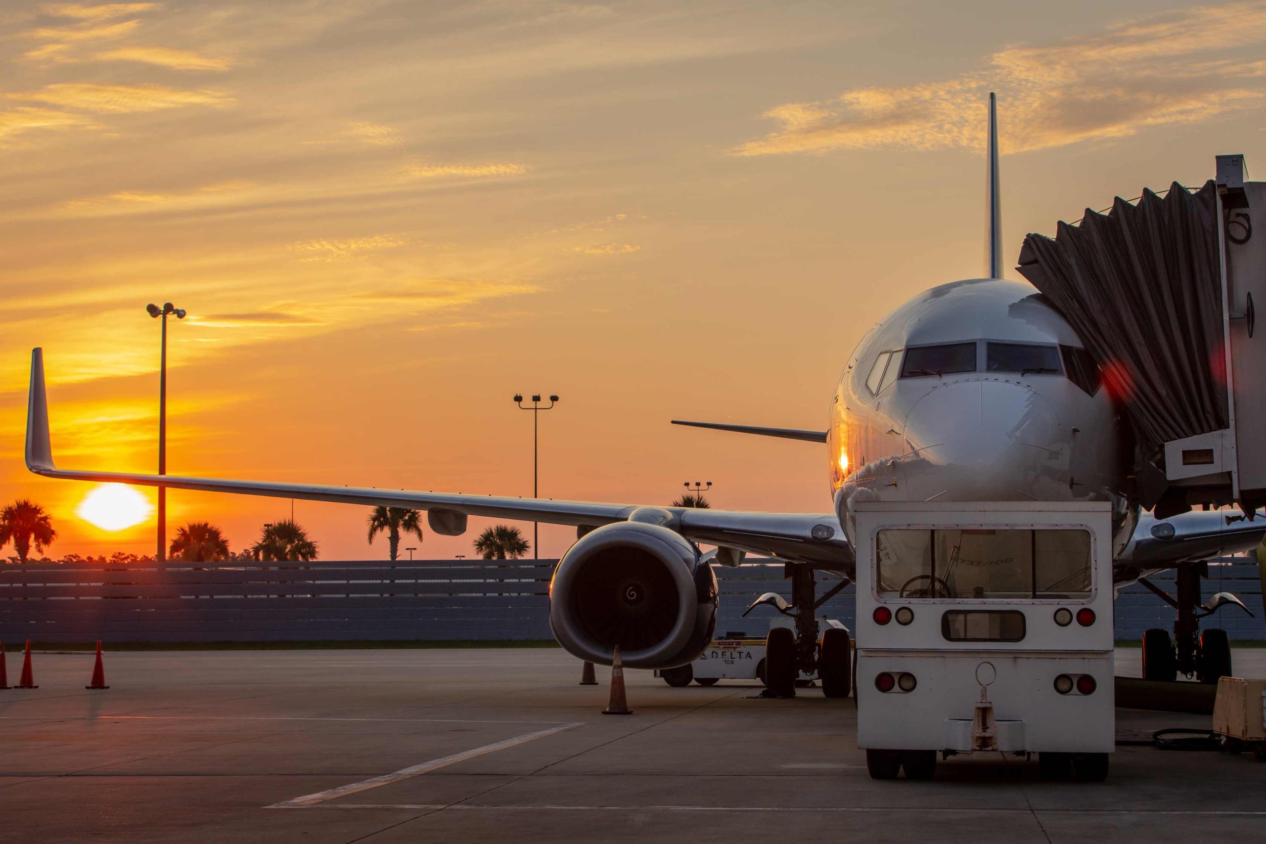 Photo of plane at VPS airport on tarmac at gate against sunset